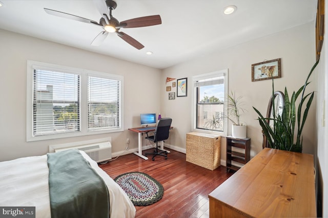 bedroom with an AC wall unit, dark hardwood / wood-style flooring, and ceiling fan