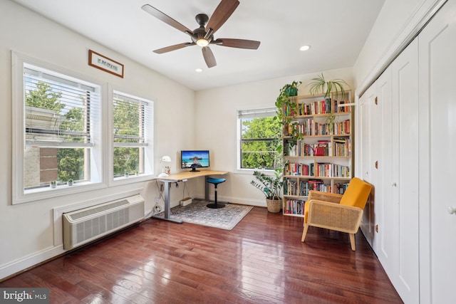 home office featuring ceiling fan, dark hardwood / wood-style floors, and a wall unit AC