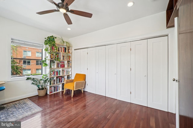 sitting room featuring ceiling fan and dark hardwood / wood-style flooring