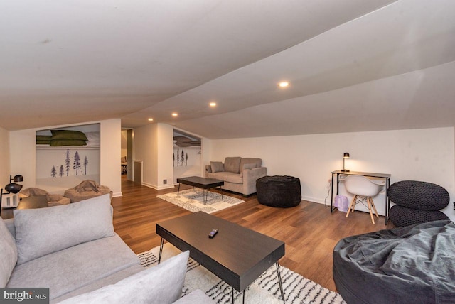 living room with wood-type flooring and lofted ceiling