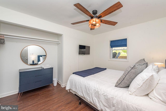 bedroom with dark hardwood / wood-style flooring and ceiling fan