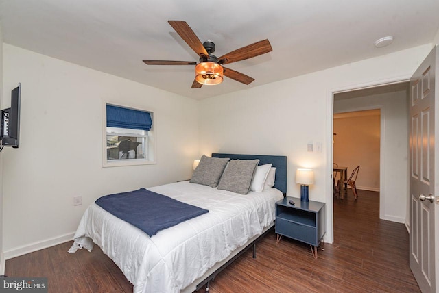 bedroom featuring dark hardwood / wood-style flooring and ceiling fan