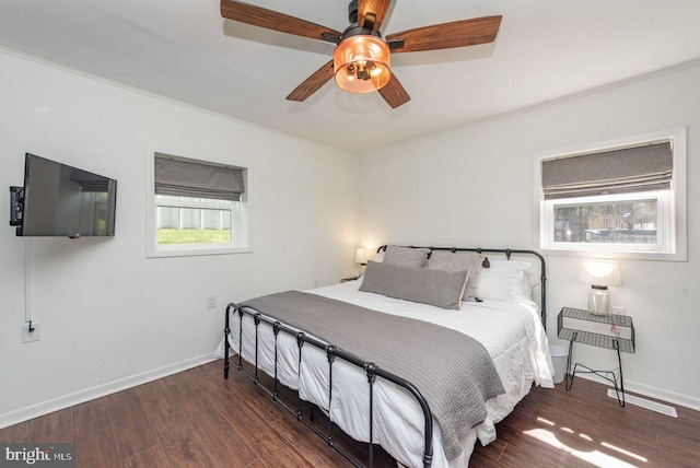 bedroom with ceiling fan and dark hardwood / wood-style floors