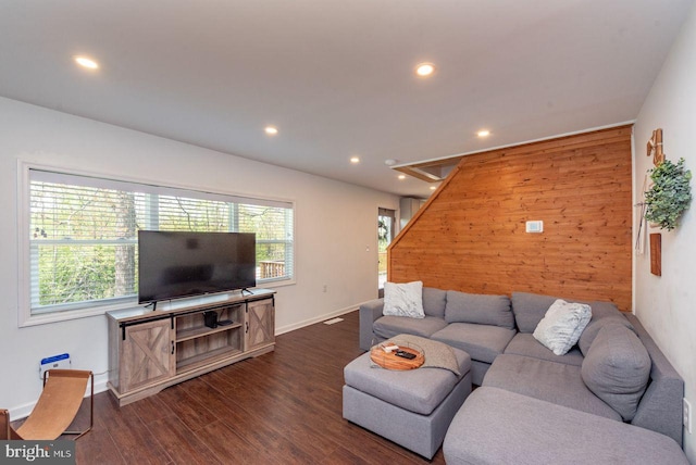 living room featuring wood walls and dark hardwood / wood-style floors