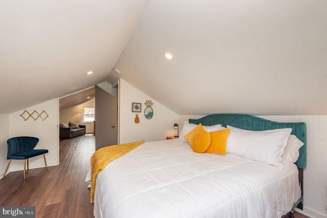 bedroom with lofted ceiling and wood-type flooring