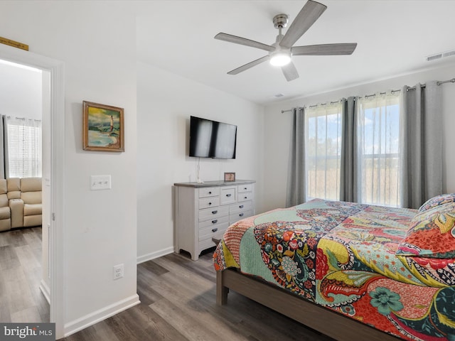 bedroom featuring multiple windows, ceiling fan, and hardwood / wood-style flooring