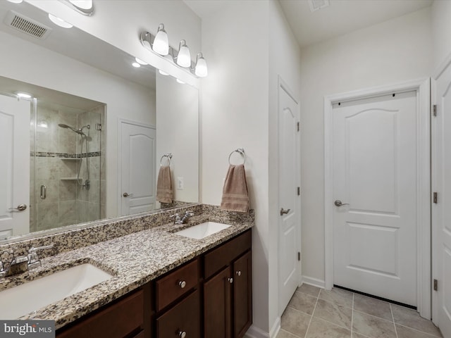 bathroom featuring tile patterned floors, vanity, and walk in shower