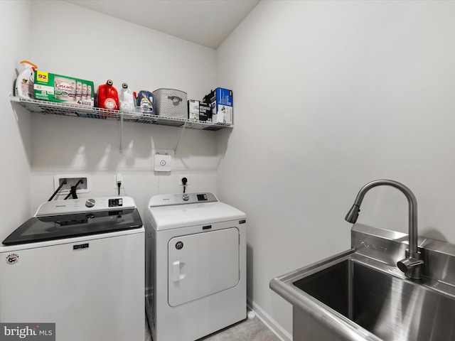 laundry area with sink and independent washer and dryer