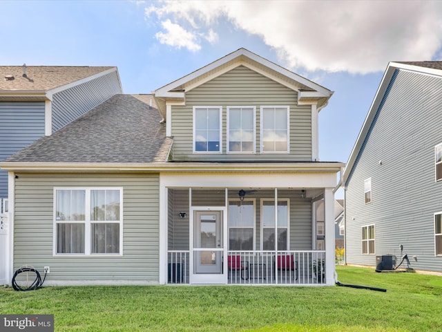 view of front facade with cooling unit and a front lawn