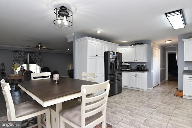 dining space featuring crown molding and ceiling fan