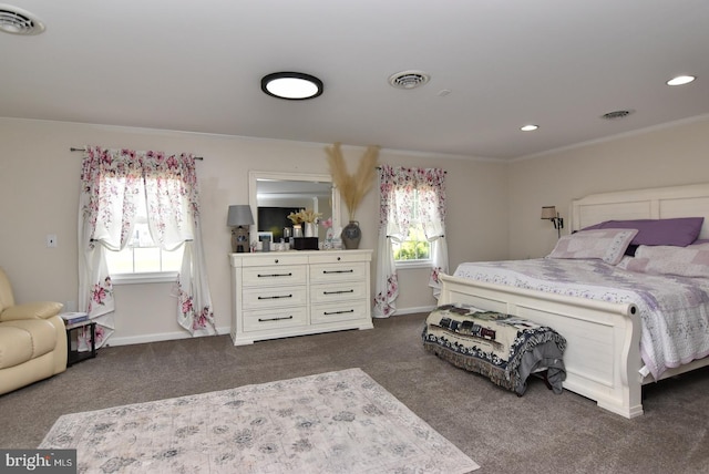 bedroom with dark carpet, ornamental molding, and multiple windows