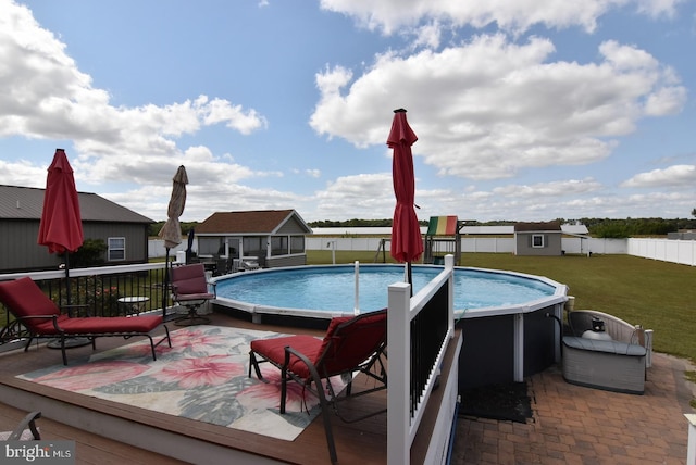 view of swimming pool with a lawn and a shed