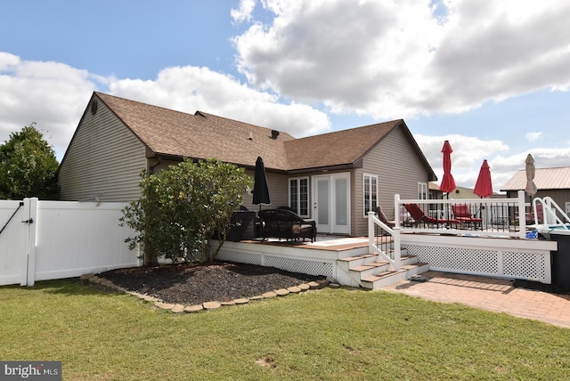 back of house with a lawn and a deck