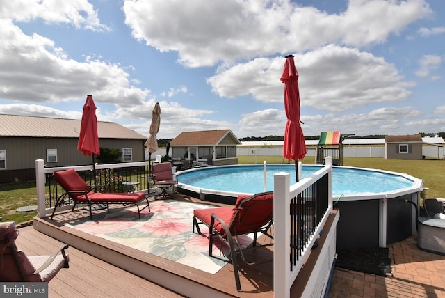 view of swimming pool featuring a patio and an outdoor structure