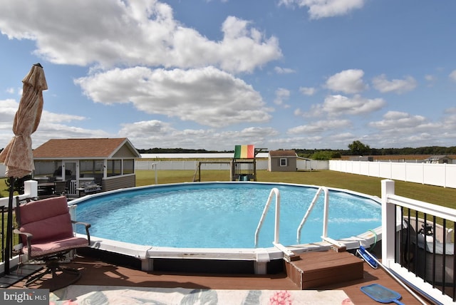 view of pool featuring a yard and an outdoor structure