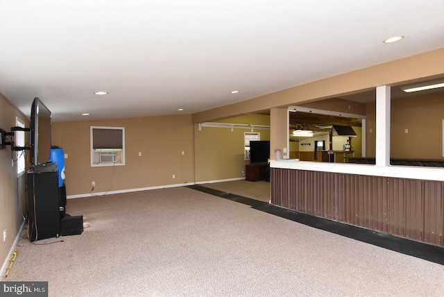 unfurnished living room featuring cooling unit and carpet