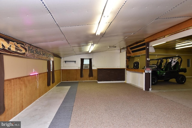 basement featuring wooden walls