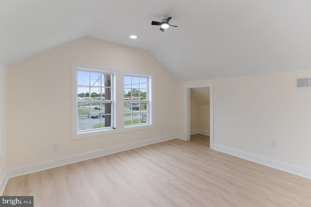 additional living space featuring lofted ceiling and light hardwood / wood-style floors