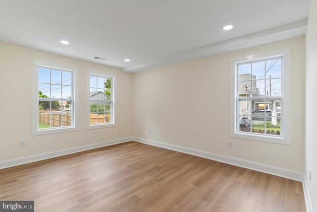 unfurnished room featuring light hardwood / wood-style floors