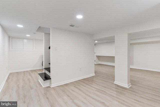 basement with light hardwood / wood-style floors