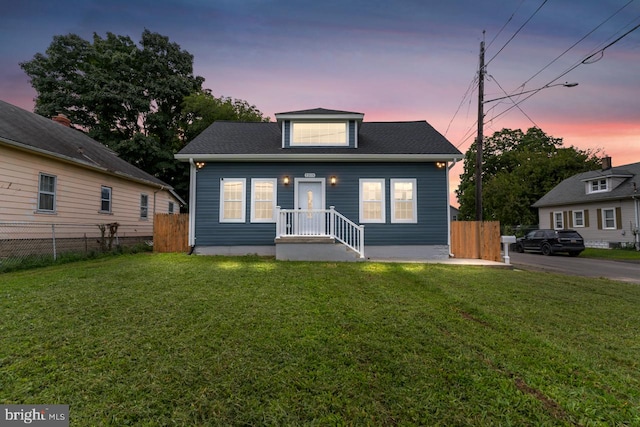 bungalow featuring a yard