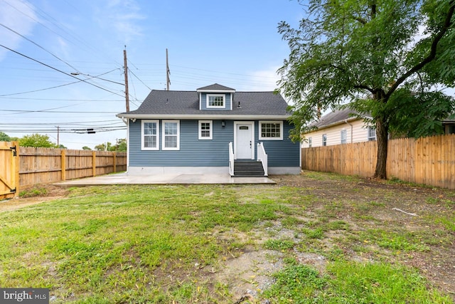 back of property featuring a patio and a yard