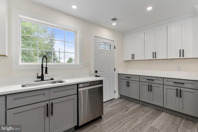 kitchen with white cabinets, gray cabinets, sink, and stainless steel dishwasher