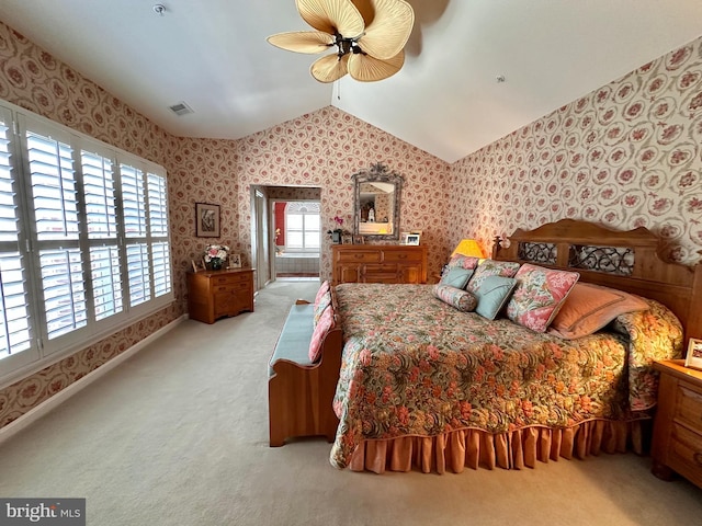 bedroom with vaulted ceiling, light carpet, visible vents, and wallpapered walls