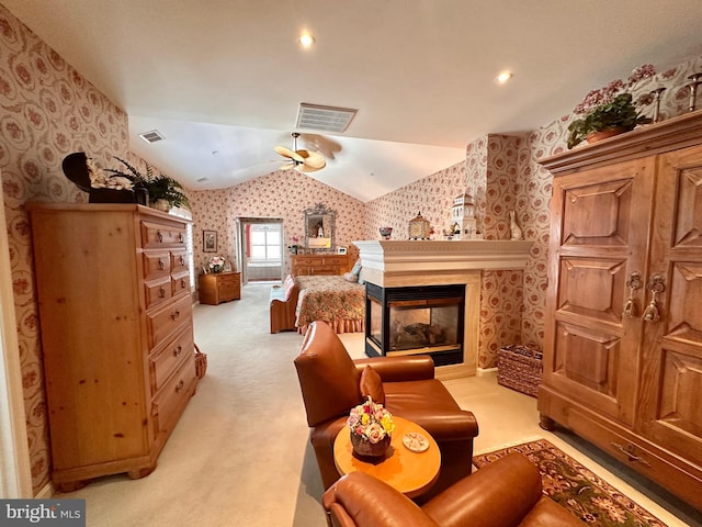 bedroom with lofted ceiling, visible vents, light colored carpet, and wallpapered walls