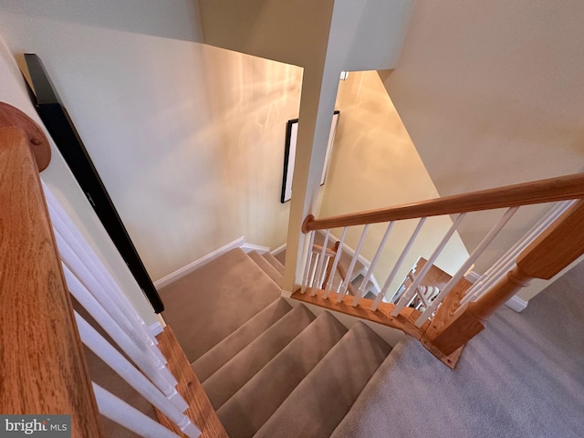 stairway with carpet and baseboards