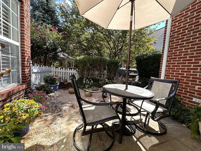 view of patio featuring fence and outdoor dining area