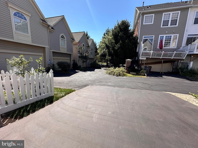 view of road featuring a residential view and driveway