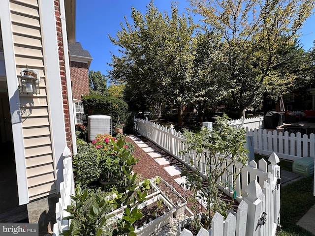 view of yard with fence and cooling unit