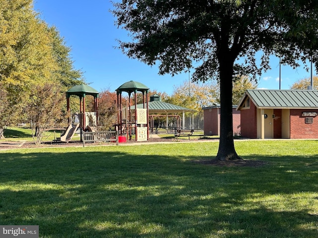 community jungle gym featuring a lawn