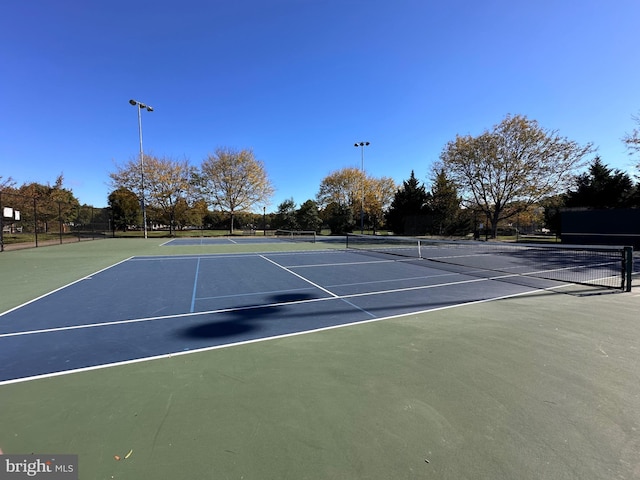 view of tennis court with fence