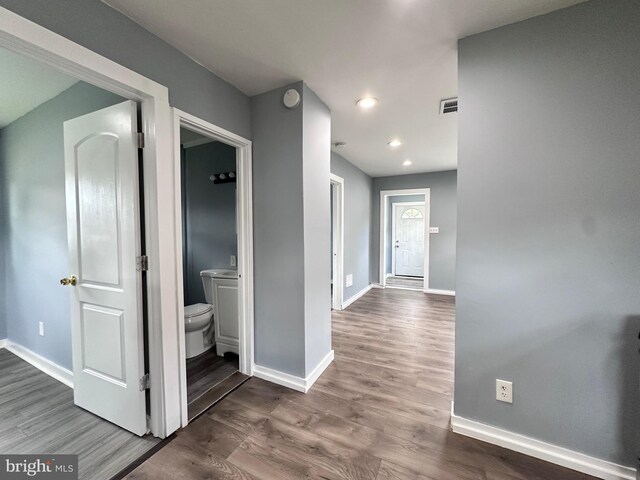 spare room featuring plenty of natural light and wood-type flooring