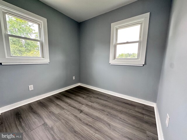 empty room with dark hardwood / wood-style floors