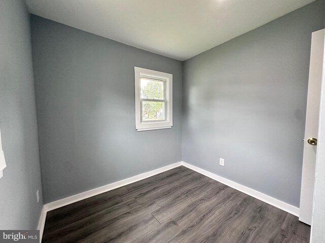 spare room featuring dark hardwood / wood-style flooring