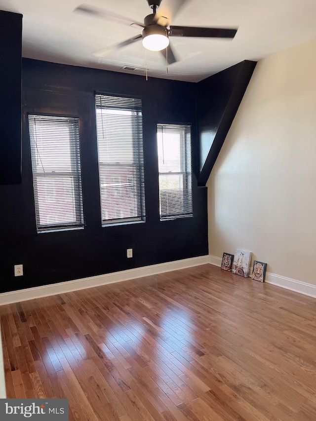 unfurnished room with hardwood / wood-style flooring and ceiling fan