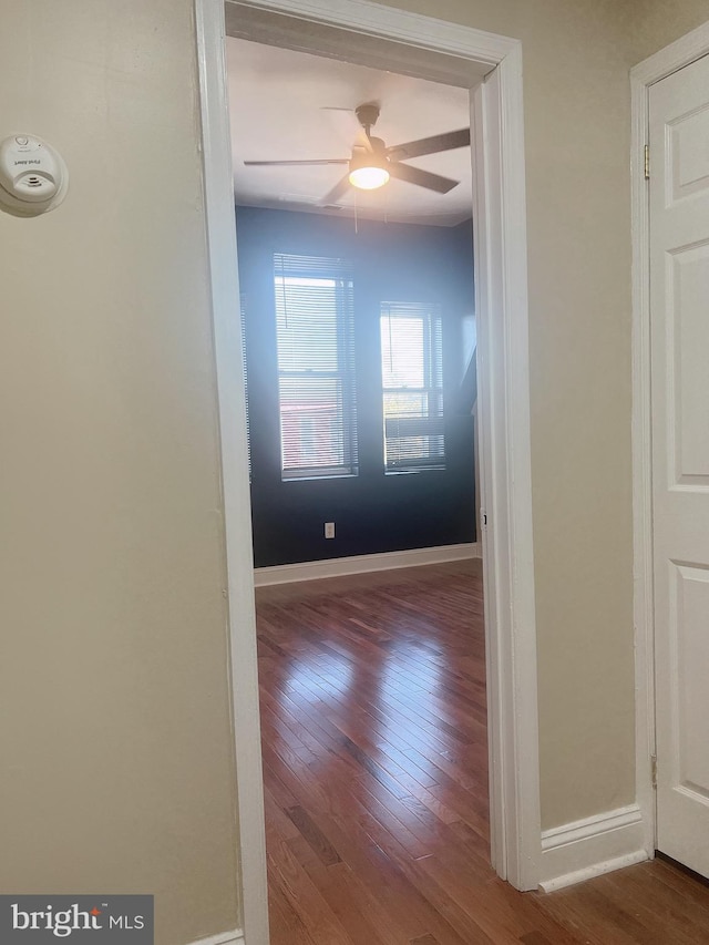 spare room with hardwood / wood-style flooring and ceiling fan