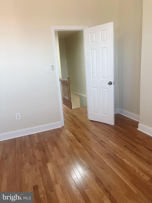 unfurnished room with hardwood / wood-style floors