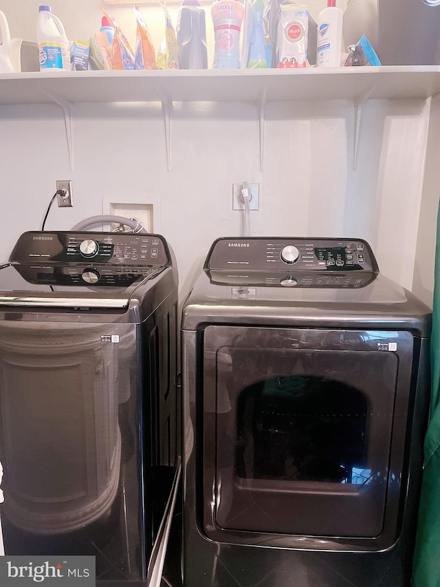 washroom with independent washer and dryer