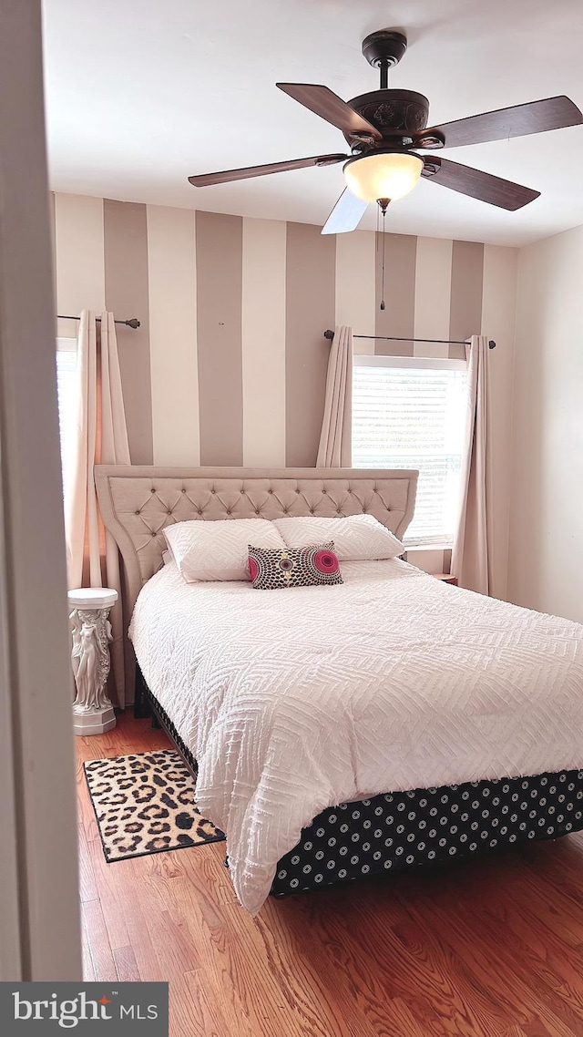 bedroom with ceiling fan and wood-type flooring