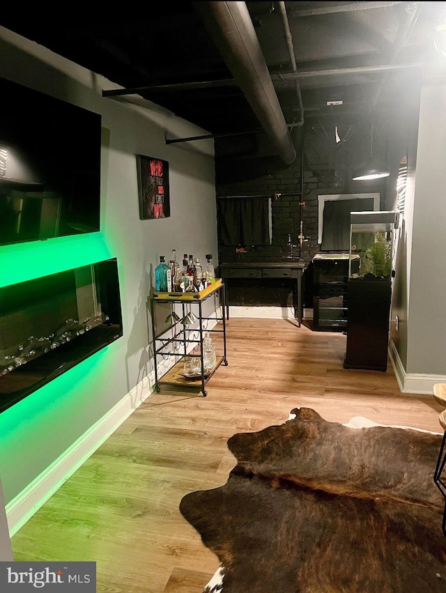 interior space with beamed ceiling and hardwood / wood-style flooring