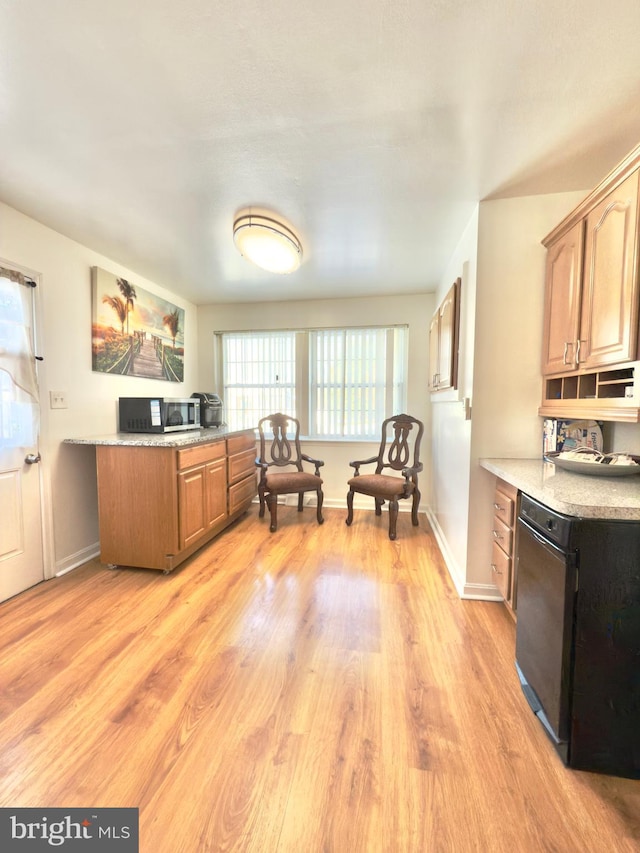 interior space featuring black dishwasher and light hardwood / wood-style flooring