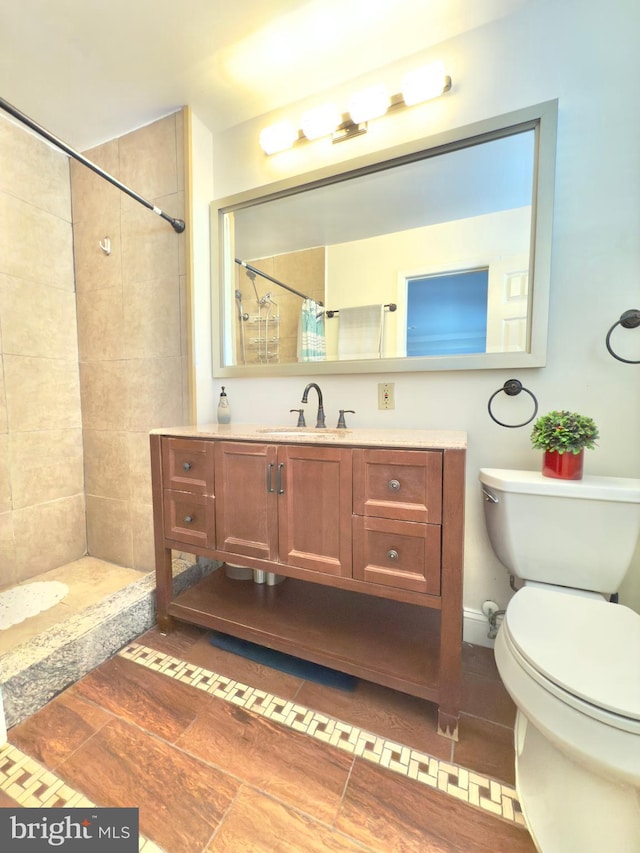 bathroom featuring vanity, a shower with curtain, tile patterned floors, and toilet