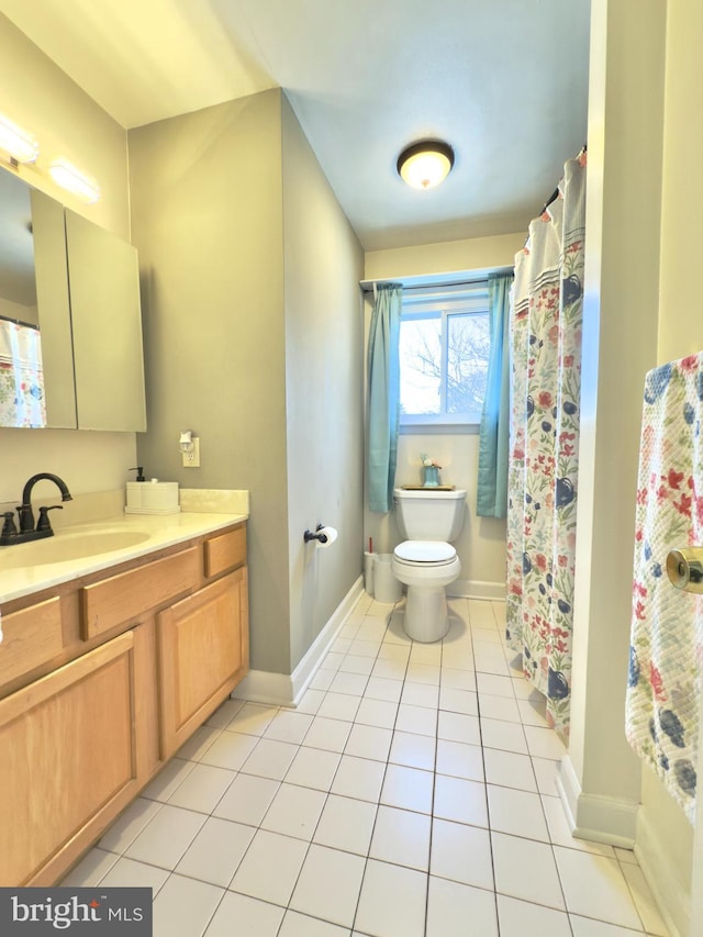 bathroom featuring vanity, tile patterned floors, and toilet