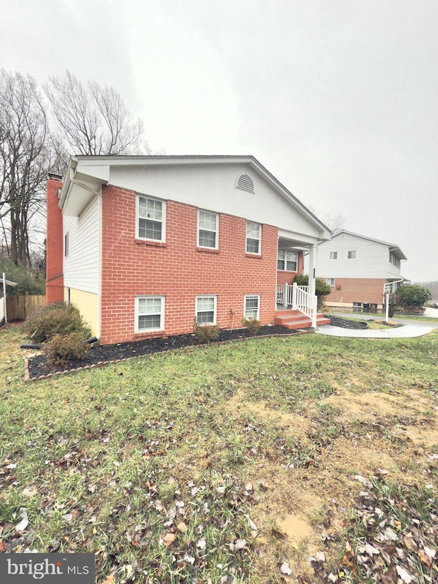 view of side of property featuring a yard and a porch