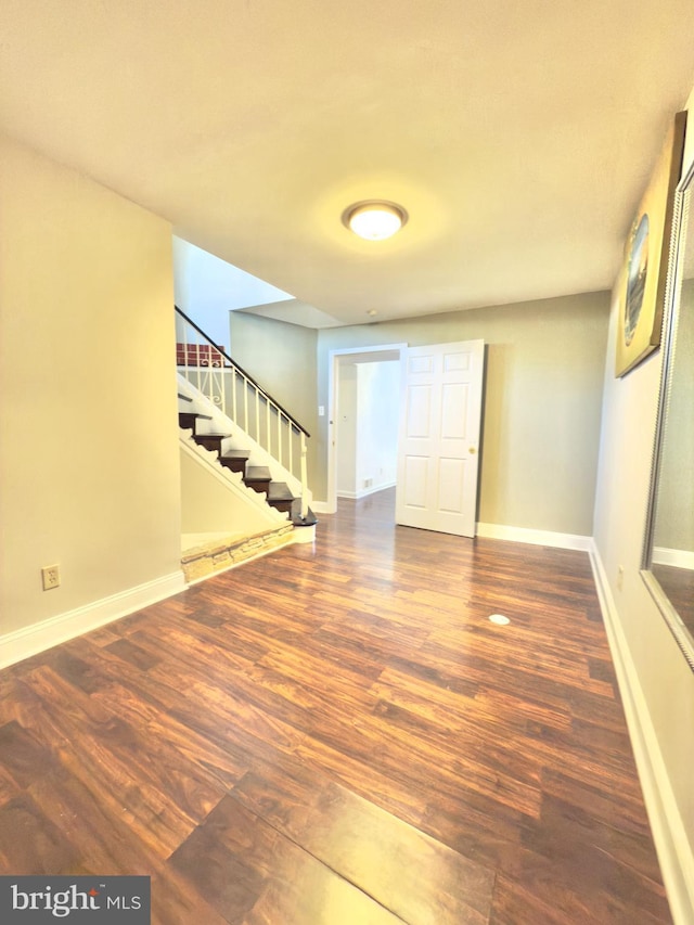 empty room with dark hardwood / wood-style flooring