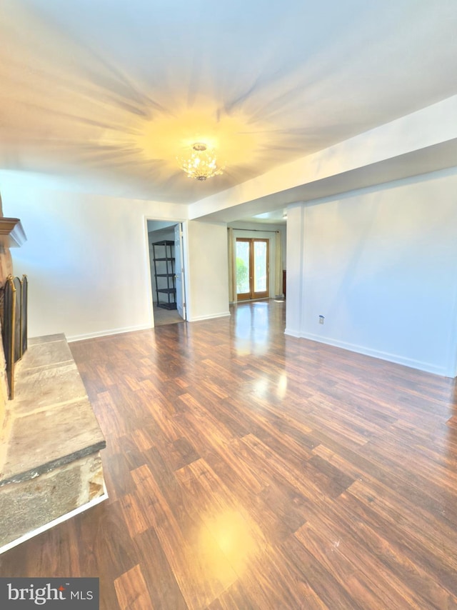 unfurnished room with dark hardwood / wood-style floors and french doors